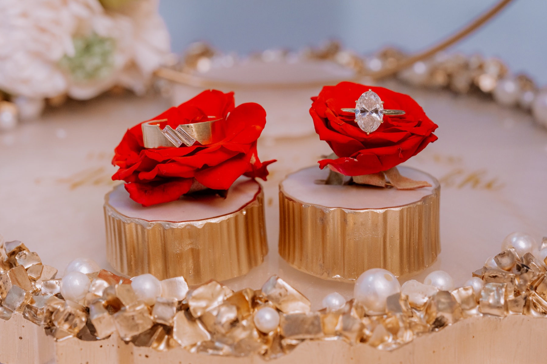 Engagement rings displayed on red roses